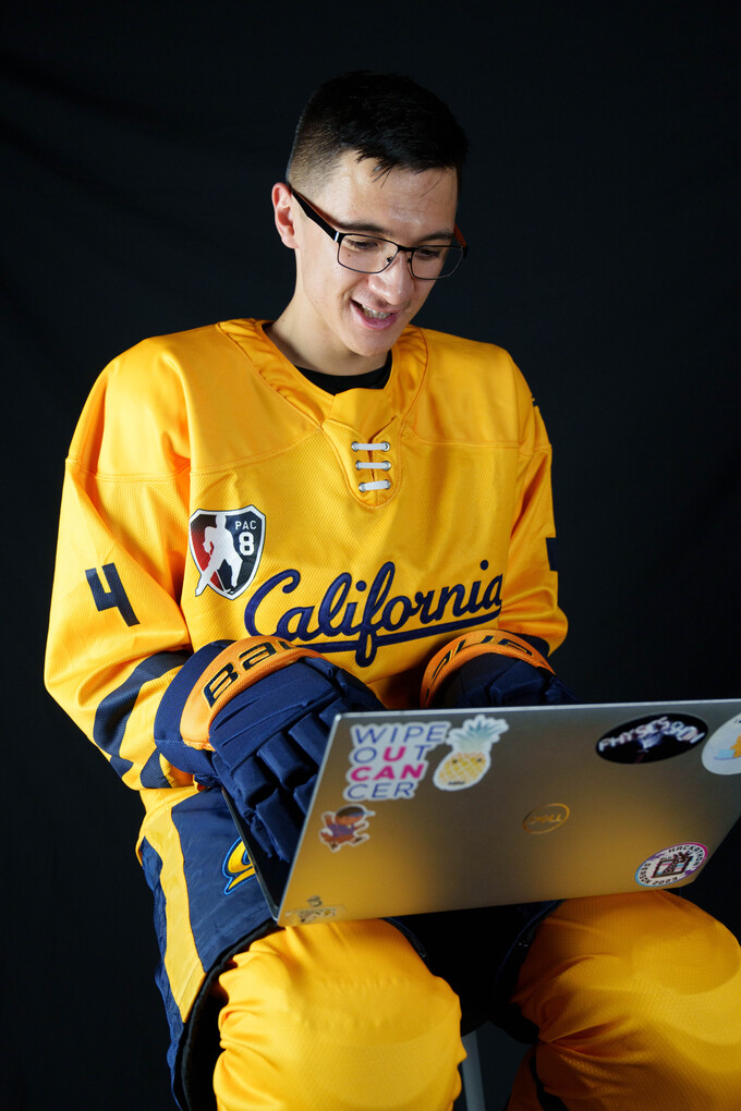 Me in my hockey gear programming on my laptop